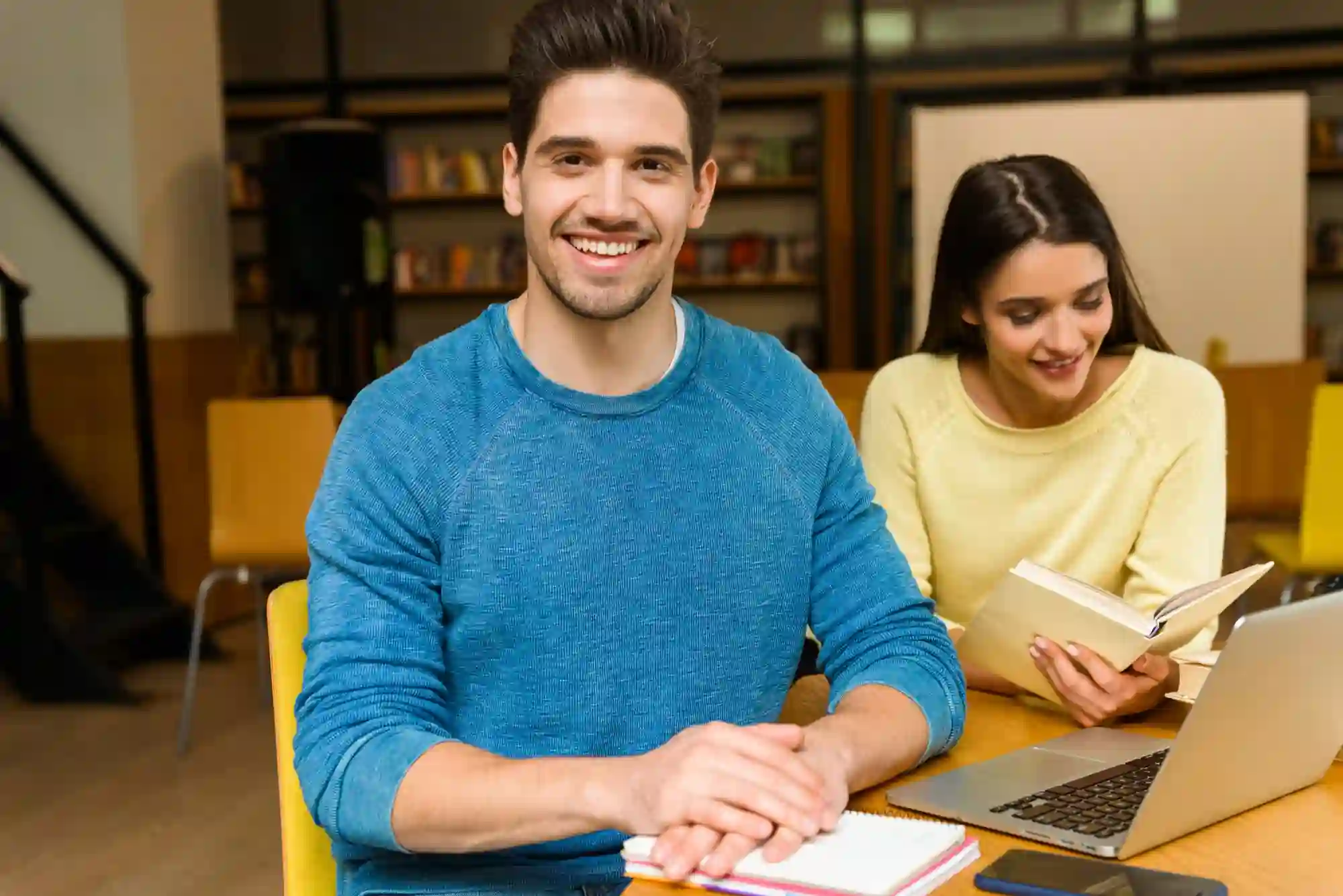 Two students preparing for the IELTS speaking cue card task