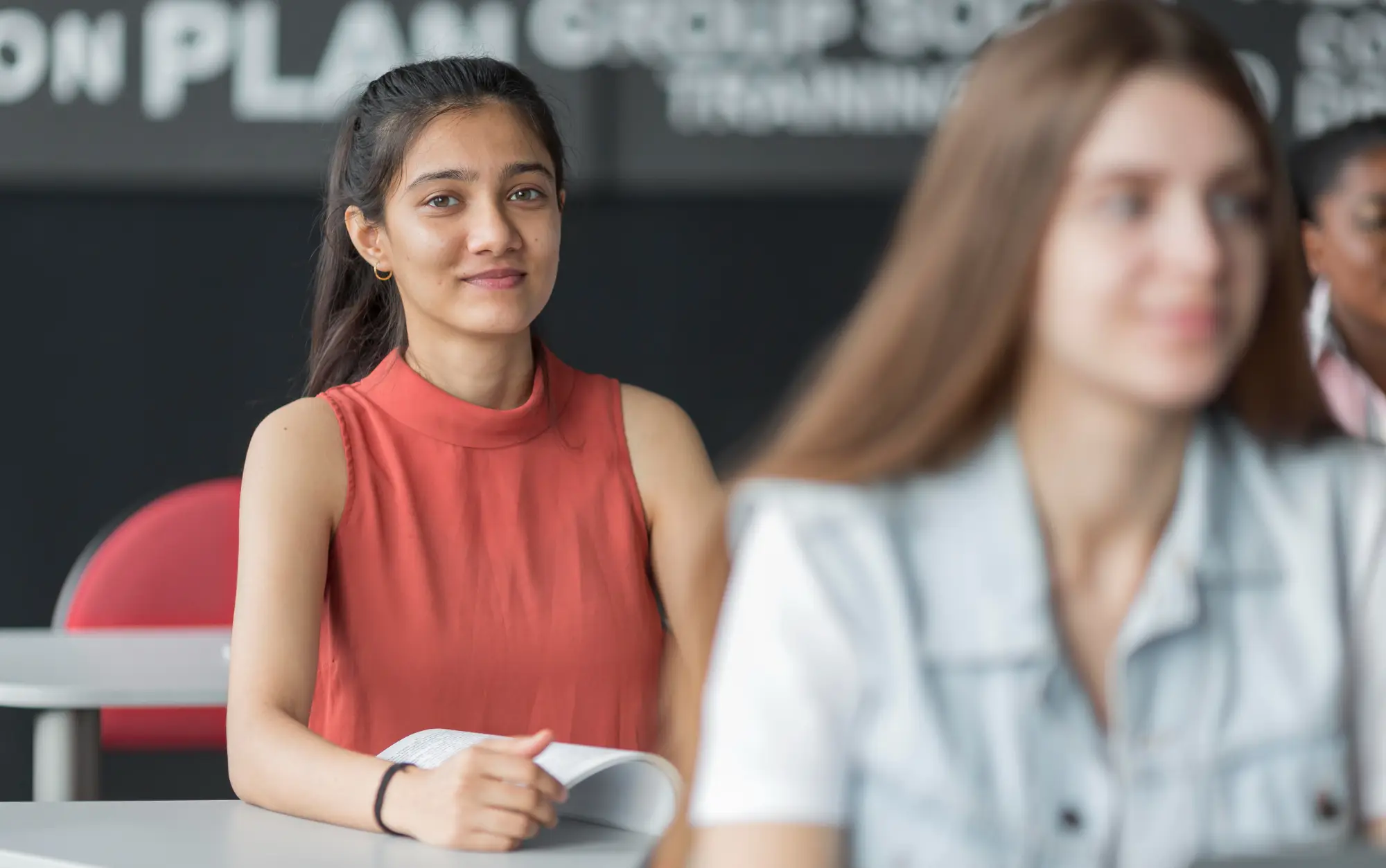 Student preparing for the IELTS speaking cue card task in a classroom