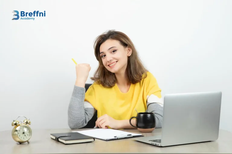 Smiling woman at a desk, symbolizing solutions to reasons applications get delayed in CORU registration