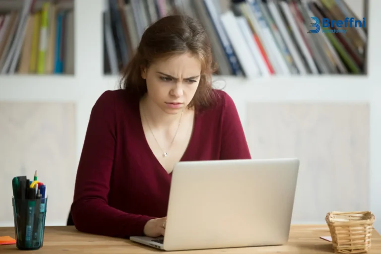 Student looking at a laptop, searching for options to reschedule or cancel IELTS test