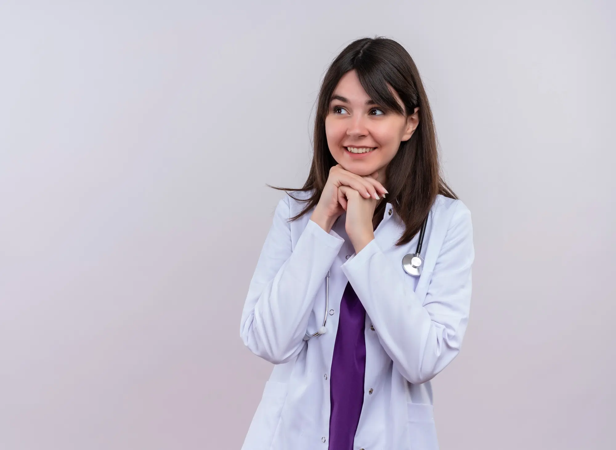 Confident female dentist in a white coat, preparing for the OET for Dentists exam