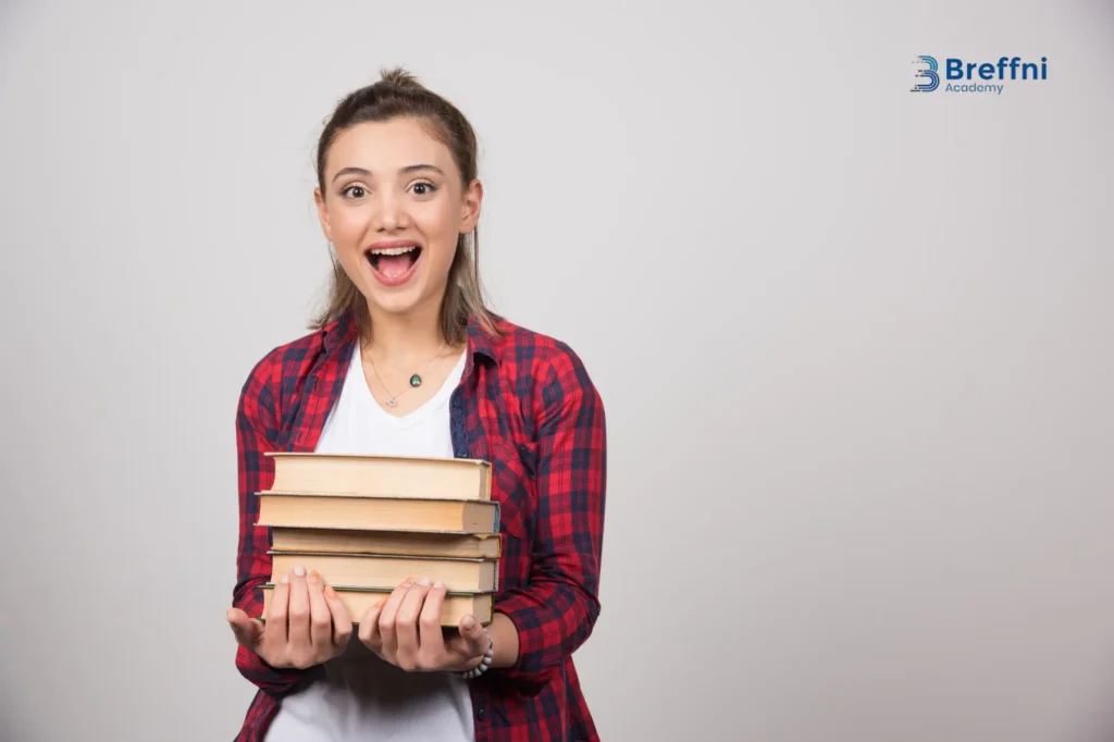 Excited student holding IELTS preparation books